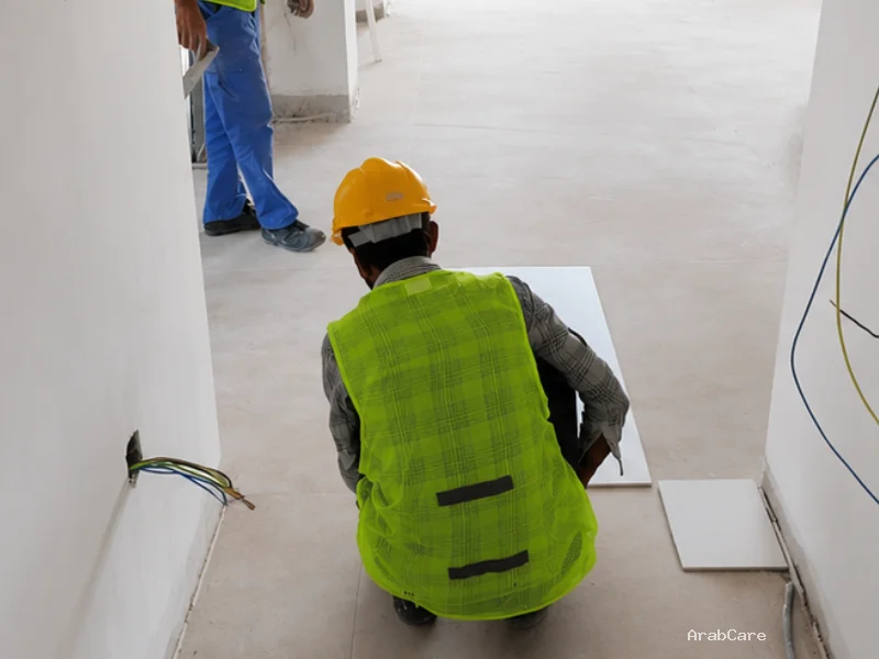 Precision tile installation in a living room by ArabCare Dubai